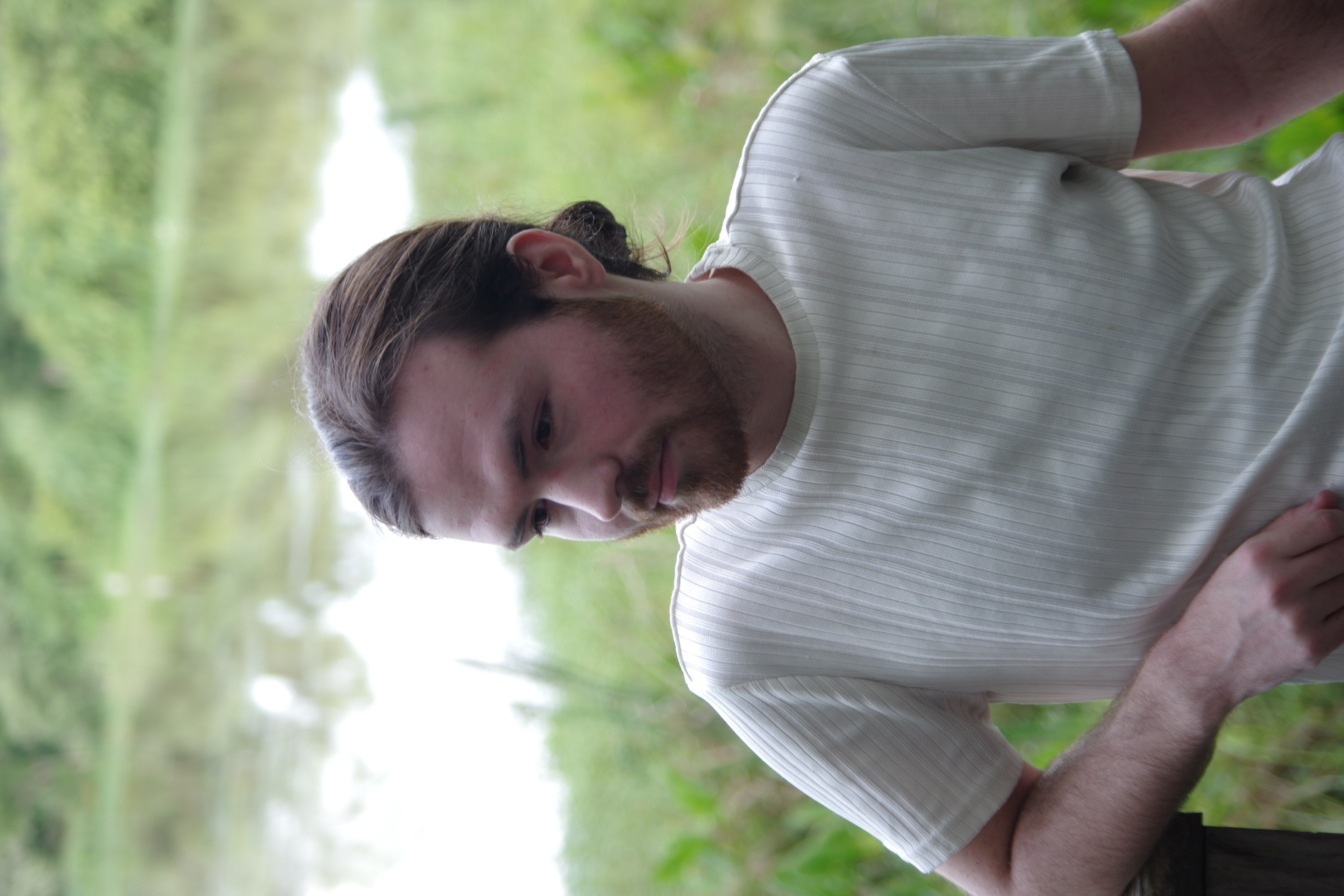 Portrait of bearded man in white shirt